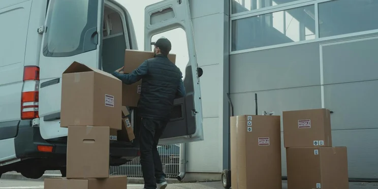 Packages are unloaded from a light-duty truck