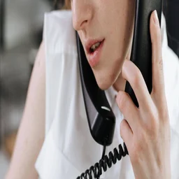 A worker placing two phone calls