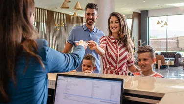 Happy family at hotel reception