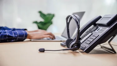 VoIP deskphone with headset on desk
