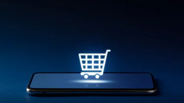 Shopping cart icon on top of mobile phone