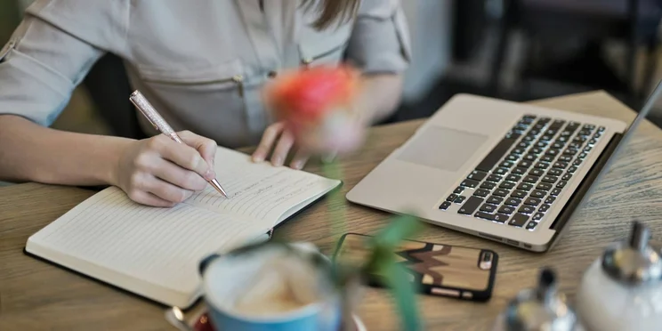 A notebook and laptop are used for learning