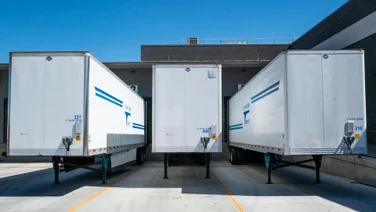 Three shipping containers in a lot
