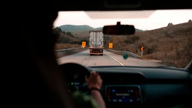 A truck is seen through another car's windshield