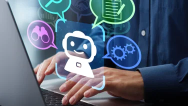 Individual typing on computer using chatbot graphic