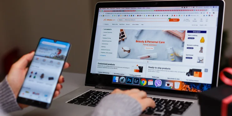 Person looking at ecommerce site on laptop and phone