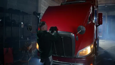 Mechanic opens a truck hood