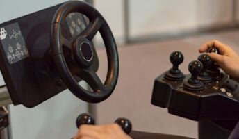Driver controlling vehicle with joystick and wheel