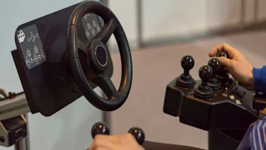 Driver controlling vehicle with joystick and wheel