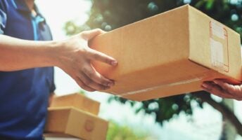 driver handing delivery to resident