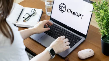 Woman on computer desk looking at chatgpt