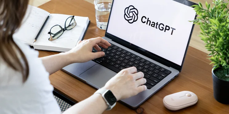 Woman on computer desk looking at chatgpt