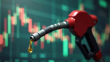 A petrol pump in front of a stock market monitor.