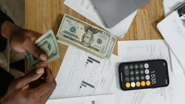 Accounting papers and money with laptop