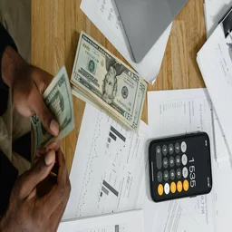 Accounting papers and money with laptop