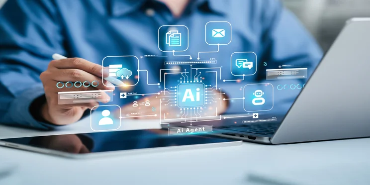 Person working on laptop with AI graphic in foreground