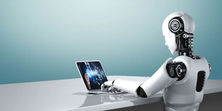 Robot Working on Laptop