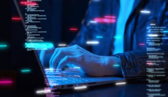 Person coding at laptop