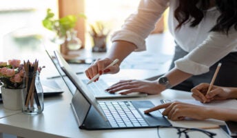 People collaborating on laptop
