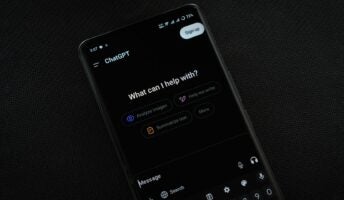 Phone on black background with ChatGPT open