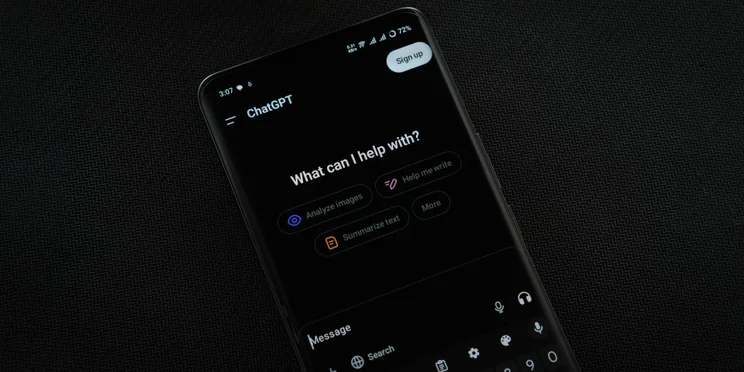 Phone on black background with ChatGPT open