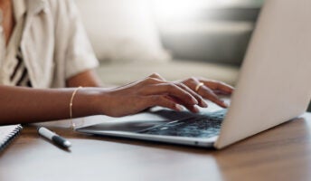 Person typing on keyboard