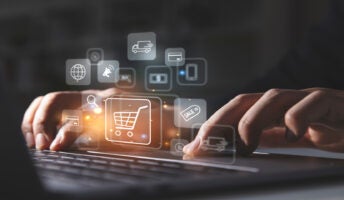 Person typing on laptop with ecommerce icons on screen
