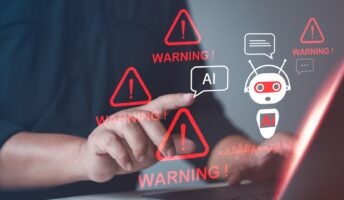 person on computer with AI dangers showing