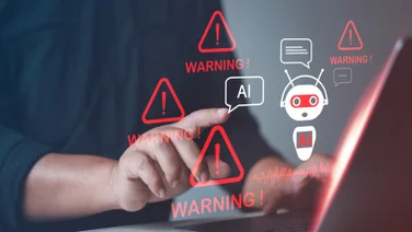 person on computer with AI dangers showing