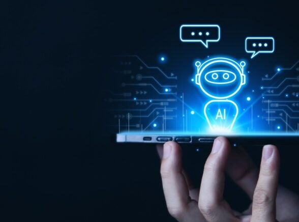 Hand holding phone with AI agent projected up