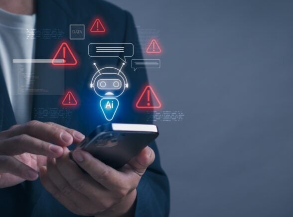 Individual on phone with AI and danger symbols graphic above