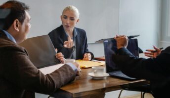 Workers with laptops at a table