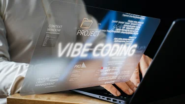 Person vibe coding on laptop