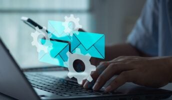 Individual on laptop with email graphic