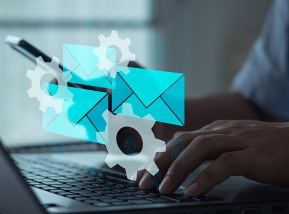 Individual on laptop with email graphic