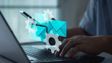 Individual on laptop with email graphic
