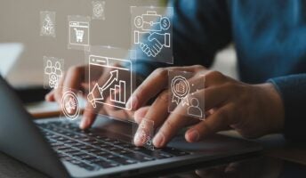 Individual on laptop using automation graphics