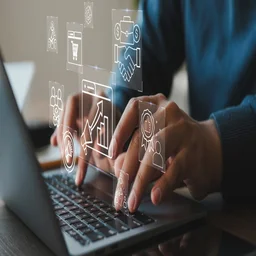 Individual on laptop using automation graphics