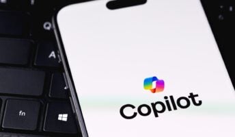 Copilot logo on phone screen on laptop keyboard
