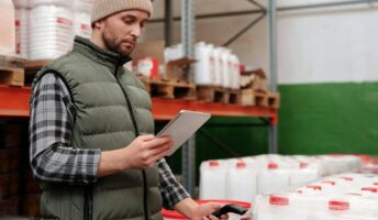 A warehouse logistics guys holds a scanner