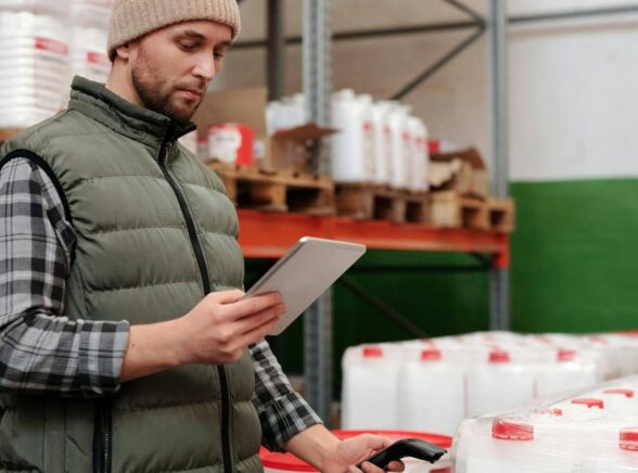 A warehouse logistics guys holds a scanner