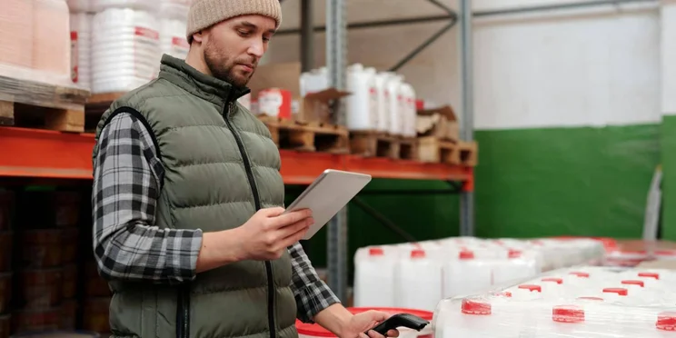 A warehouse logistics guys holds a scanner