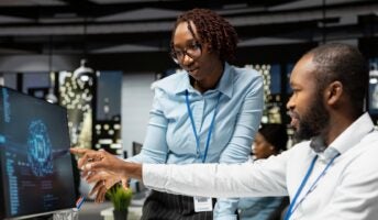 Employees looking at monitor on AI use