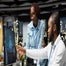 Employees looking at monitor on AI use