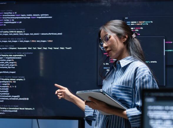 Woman presenting code work in office