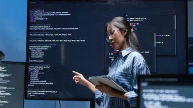 Woman presenting code work in office