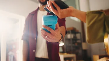 Person paying with their mobile phone