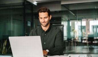 Happy office worker on laptop