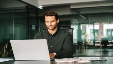 Happy office worker on laptop