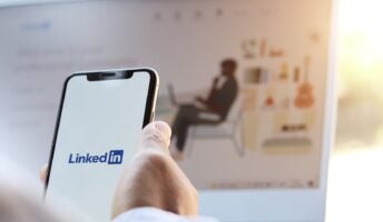 LinkedIn on phone and on background